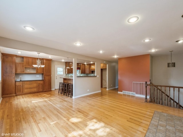 235 S Cedar St, Palatine, IL 60067 - unfurnished living room featuring light wood finished floors, recessed lighting, and a chandelier