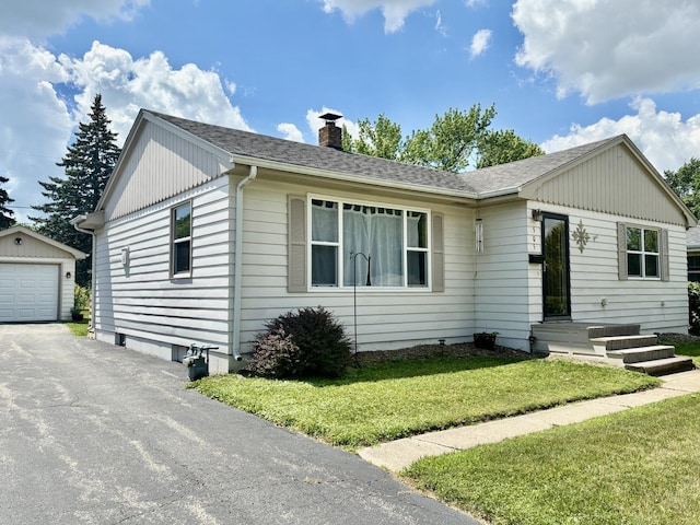 505 Highland St, Belvidere, IL 61008 - ranch-style home with an outdoor structure, a chimney, asphalt driveway, a front lawn, and roof with shingles