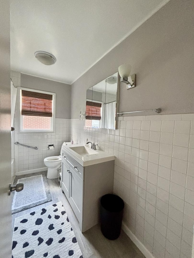 505 Highland St, Belvidere, IL 61008 - bathroom with tile walls, vanity, and wainscoting