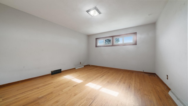 4209 Rotary Rd, Rockford, IL 61109 - spare room featuring wood finished floors and baseboard heating