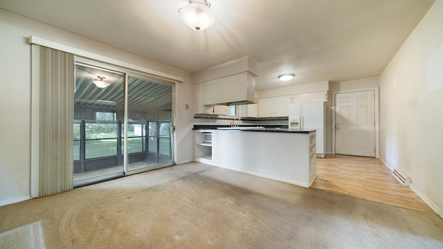 4209 Rotary Rd, Rockford, IL 61109 - kitchen with white appliances, light carpet, dark countertops, white cabinetry, and a peninsula