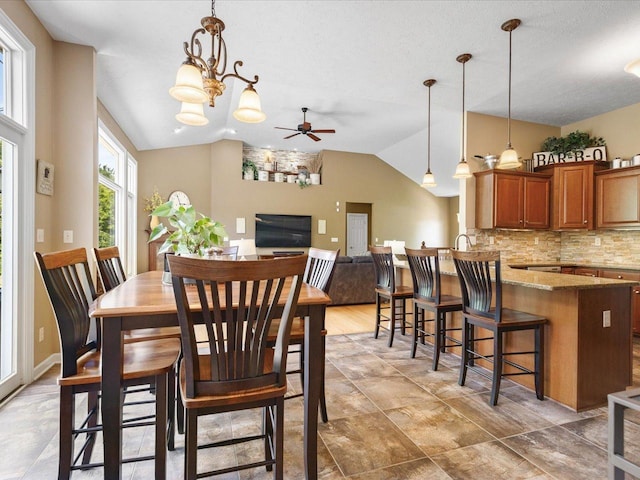 7681 Highlands Dr, Rockford, IL 61102 - dining space featuring vaulted ceiling, a ceiling fan, and a chandelier