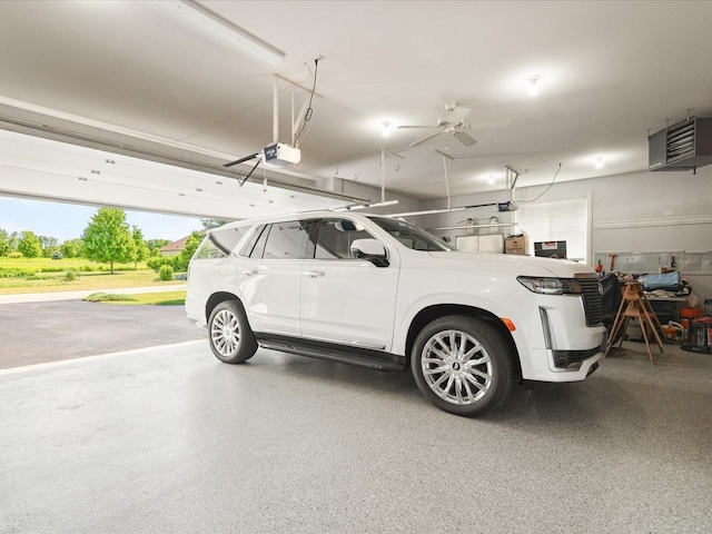 7681 Highlands Dr, Rockford, IL 61102 - garage featuring a garage door opener and a ceiling fan