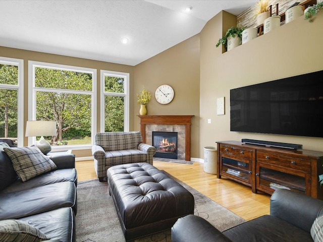 7681 Highlands Dr, Rockford, IL 61102 - living area featuring wood finished floors, lofted ceiling, a fireplace, and recessed lighting