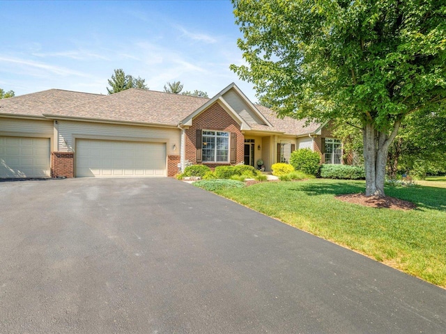 7681 Highlands Dr, Rockford, IL 61102 - single story home featuring brick siding, driveway, an attached garage, and a front lawn
