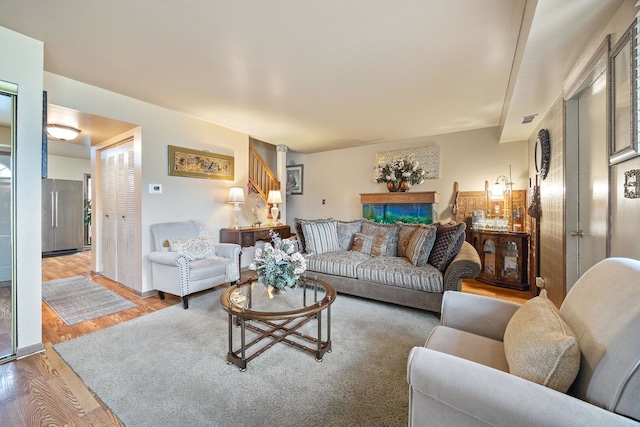 2626 E Martha Pl, Burnham, IL 60633 - living room with light wood-style floors and stairs