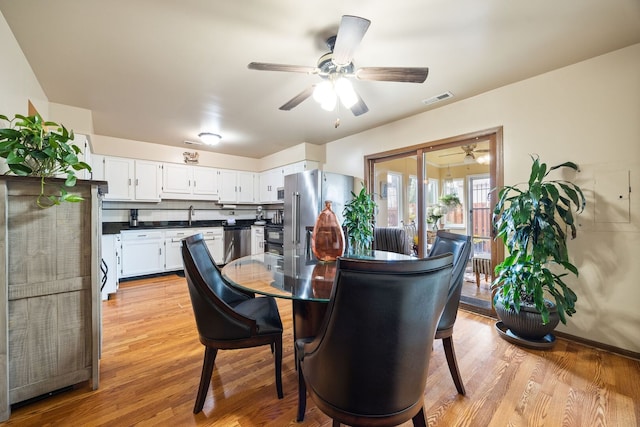 2626 E Martha Pl, Burnham, IL 60633 - dining space featuring ceiling fan and light wood-type flooring