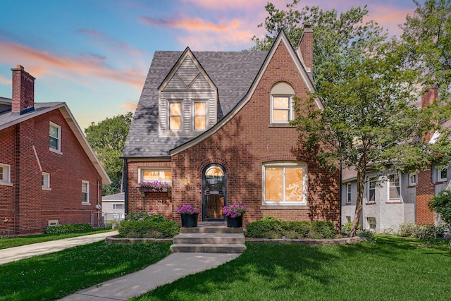 9146 S Hamilton Ave, Chicago, IL 60643 - tudor house with a lawn, brick siding, roof with shingles, and a chimney