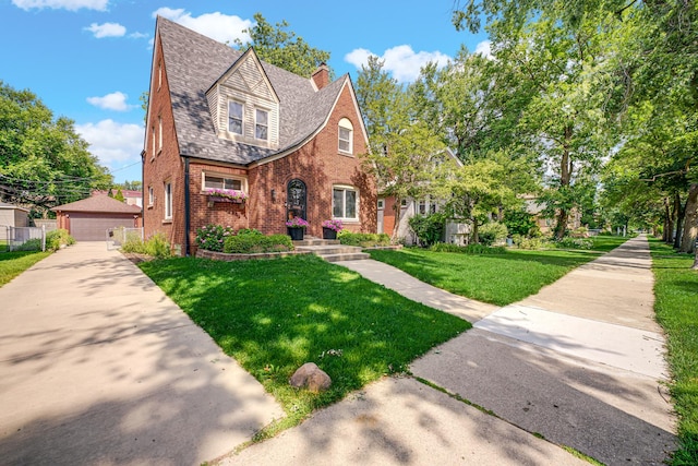 9146 S Hamilton Ave, Chicago, IL 60643 - tudor home with brick siding, a chimney, a front yard, a detached garage, and an outdoor structure