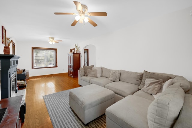 9146 S Hamilton Ave, Chicago, IL 60643 - living room with arched walkways, wood finished floors, a ceiling fan, and a fireplace
