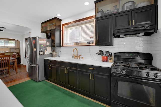 9146 S Hamilton Ave, Chicago, IL 60643 - kitchen with black gas stove, freestanding refrigerator, under cabinet range hood, light countertops, and ornamental molding