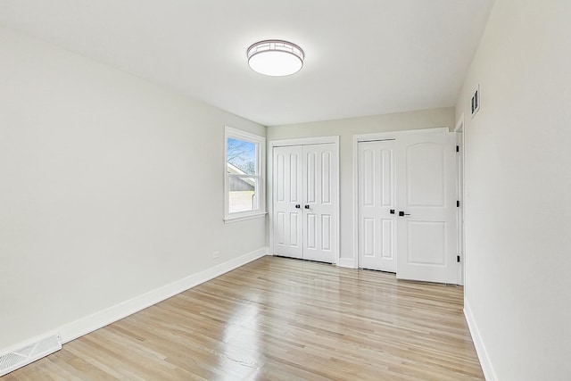 2024 E Wintergreen Ave, Mount Prospect, IL 60056 - unfurnished bedroom with two closets and light wood finished floors