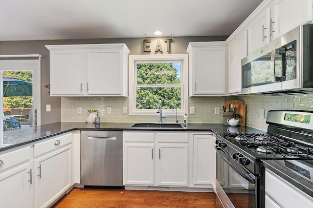 105 Devonshire Dr, Dekalb, IL 60115 - kitchen featuring appliances with stainless steel finishes, white cabinetry, tasteful backsplash, plenty of natural light, and recessed lighting
