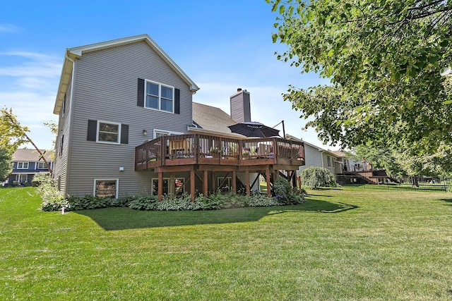 105 Devonshire Dr, Dekalb, IL 60115 - back of house with a deck, a lawn, and a chimney