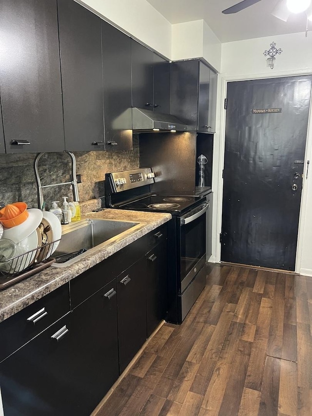8710 Skokie Blvd Unit 1A, Skokie, IL 60077 - kitchen featuring stainless steel range with electric cooktop, under cabinet range hood, dark cabinets, dark wood finished floors, and tasteful backsplash