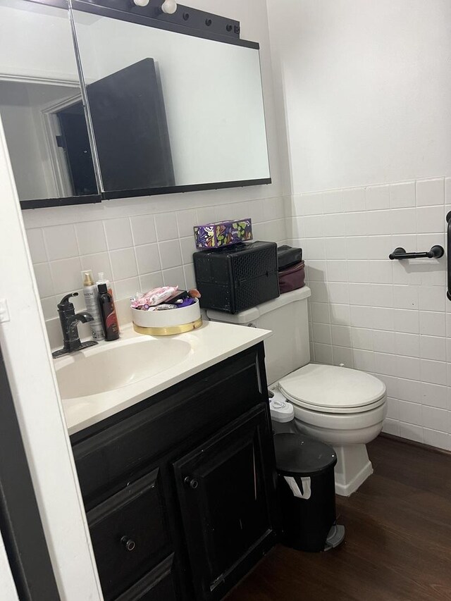 8710 Skokie Blvd Unit 1A, Skokie, IL 60077 - bathroom featuring tile walls, wood finished floors, vanity, and a wainscoted wall