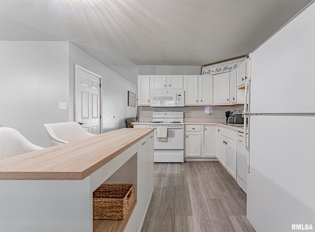 145 White Ave, Lincoln, IL 62656 - kitchen with white appliances, light wood finished floors, white cabinets, wooden counters, and a kitchen island