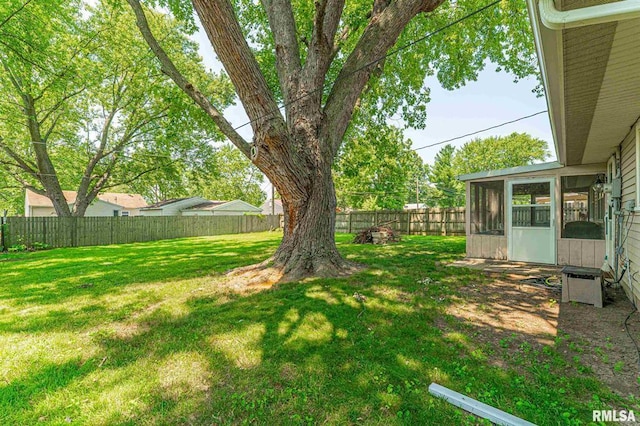 145 White Ave, Lincoln, IL 62656 - fenced backyard featuring a sunroom