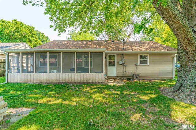 145 White Ave, Lincoln, IL 62656 - ranch-style house with a front lawn and a sunroom