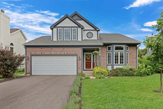 330 Dorchester Ln, Grayslake, IL 60030 - traditional-style home featuring asphalt driveway, a front lawn, brick siding, and a garage