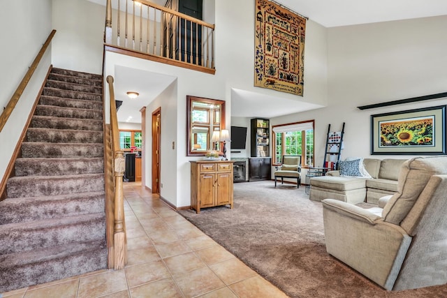 330 Dorchester Ln, Grayslake, IL 60030 - living room with a towering ceiling, light tile patterned floors, stairway, and light colored carpet