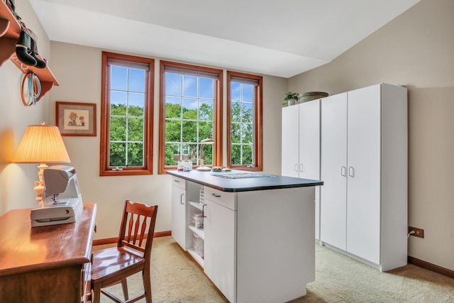 330 Dorchester Ln, Grayslake, IL 60030 - kitchen with light colored carpet, white cabinets, a center island, and a desk