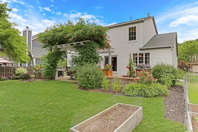 330 Dorchester Ln, Grayslake, IL 60030 - back of property with a vegetable garden and roof with shingles