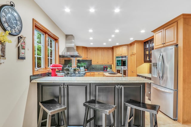 330 Dorchester Ln, Grayslake, IL 60030 - kitchen with stainless steel appliances, wall chimney range hood, a peninsula, decorative backsplash, and recessed lighting