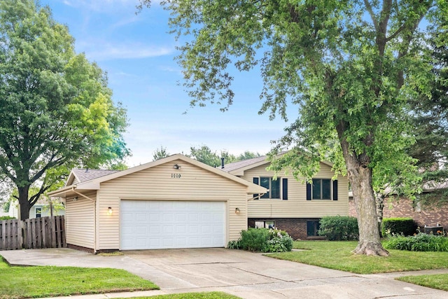 1219 Nicki Dr, Bloomington, IL 61704 - tri-level home featuring driveway and a garage