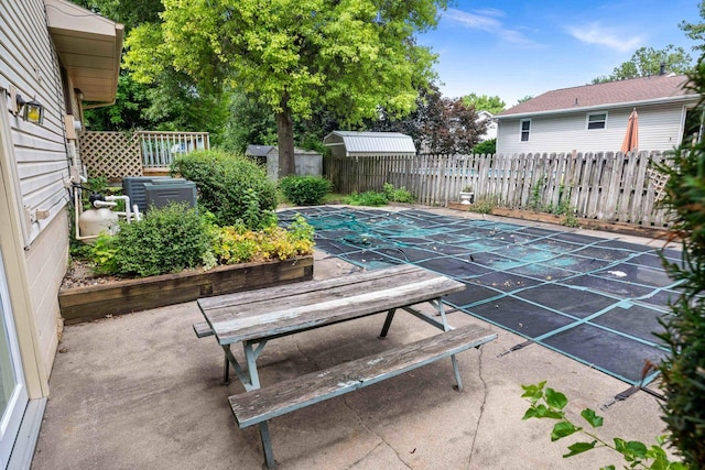 1219 Nicki Dr, Bloomington, IL 61704 - fenced backyard with a patio, a shed, and outdoor dining space