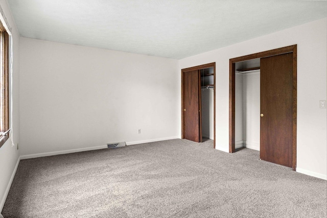 1219 Nicki Dr, Bloomington, IL 61704 - unfurnished bedroom with carpet and two closets