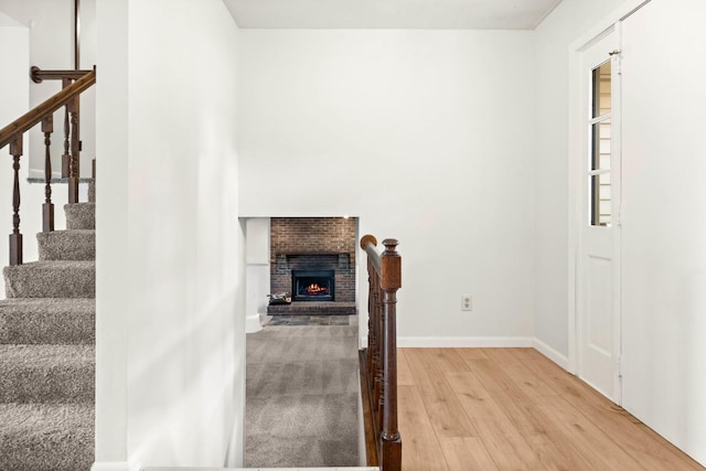 1219 Nicki Dr, Bloomington, IL 61704 - entryway with light wood-style floors, stairway, and a fireplace