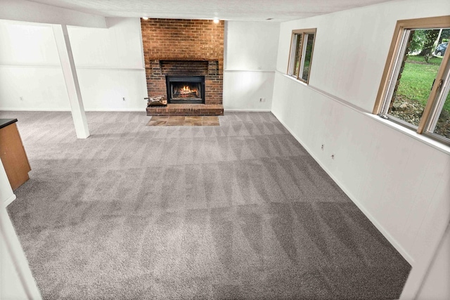1219 Nicki Dr, Bloomington, IL 61704 - unfurnished living room featuring carpet and a fireplace