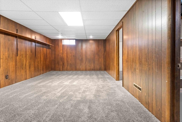 1219 Nicki Dr, Bloomington, IL 61704 - below grade area featuring carpet flooring, wooden walls, and a paneled ceiling