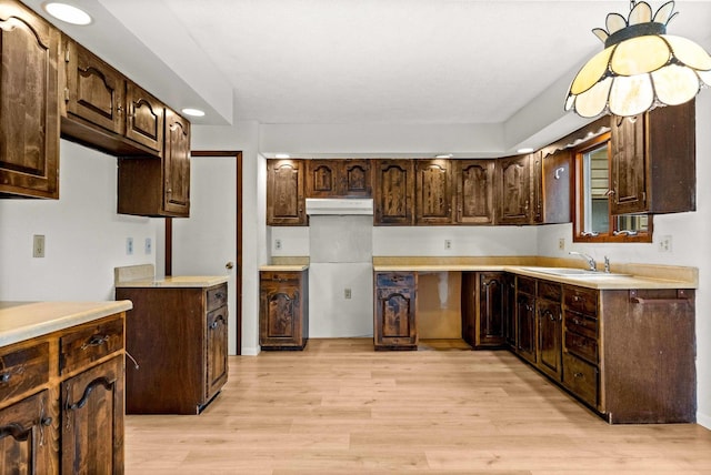 1219 Nicki Dr, Bloomington, IL 61704 - kitchen featuring light wood finished floors, dark brown cabinetry, recessed lighting, and light countertops