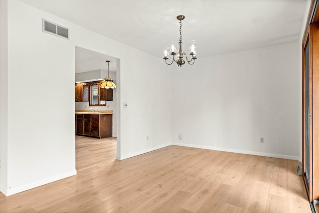 1219 Nicki Dr, Bloomington, IL 61704 - unfurnished dining area with a chandelier and light wood-style floors