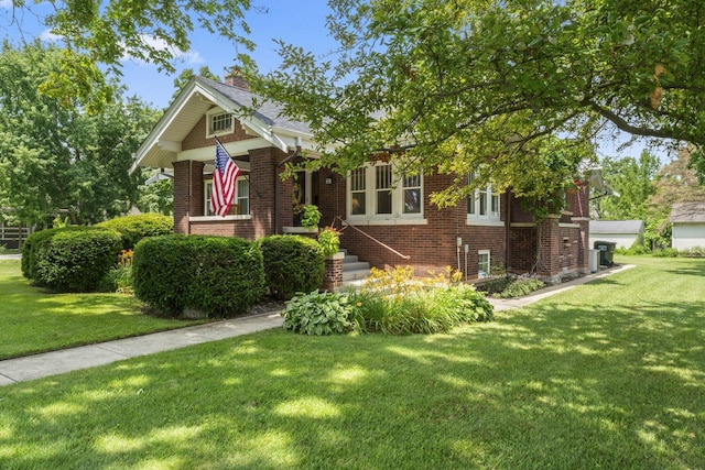 321 W Chebanse Ave, Chebanse, IL 60922 - view of front of property featuring brick siding, a front lawn, and a chimney