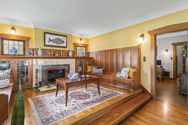 321 W Chebanse Ave, Chebanse, IL 60922 - living room with crown molding, a tiled fireplace, and wood finished floors