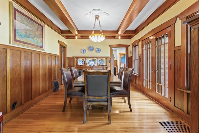 321 W Chebanse Ave, Chebanse, IL 60922 - dining space featuring beam ceiling, a wainscoted wall, light wood-type flooring, and french doors