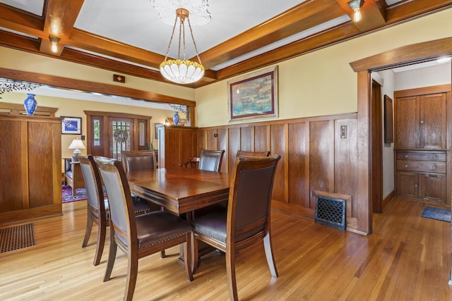 321 W Chebanse Ave, Chebanse, IL 60922 - dining room with light wood-style flooring, a wainscoted wall, and a chandelier