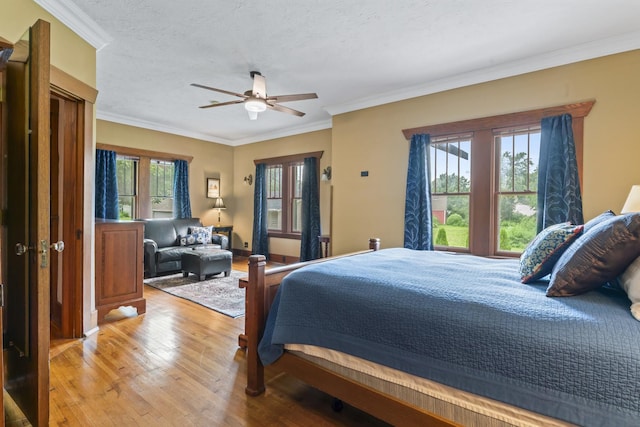 321 W Chebanse Ave, Chebanse, IL 60922 - bedroom featuring multiple windows, light wood-style flooring, ornamental molding, and a ceiling fan