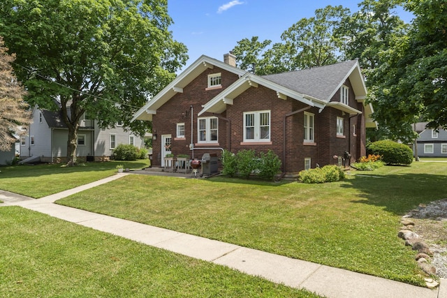 321 W Chebanse Ave, Chebanse, IL 60922 - view of front of property featuring a chimney, brick siding, a front lawn, and a patio