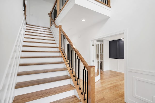 16540 Pear Ave, Orland Park, IL 60467 - staircase with a decorative wall, wood finished floors, and wainscoting
