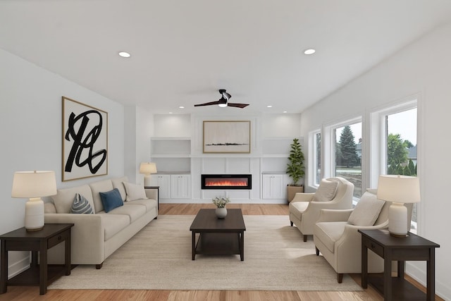 16540 Pear Ave, Orland Park, IL 60467 - living area with a ceiling fan, light wood-style flooring, a glass covered fireplace, built in shelves, and recessed lighting