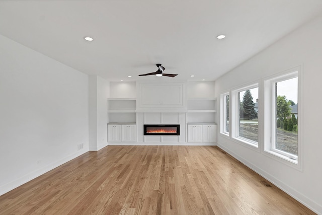 16540 Pear Ave, Orland Park, IL 60467 - unfurnished living room with a glass covered fireplace, light wood-style flooring, ceiling fan, recessed lighting, and built in shelves