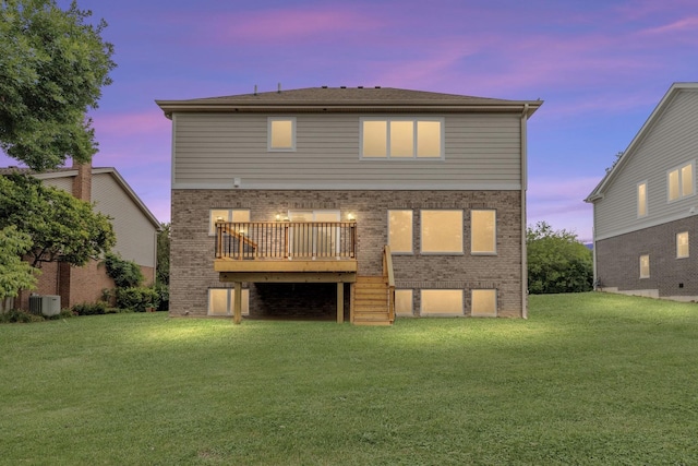 16540 Pear Ave, Orland Park, IL 60467 - back of property at dusk featuring a wooden deck, brick siding, and a lawn