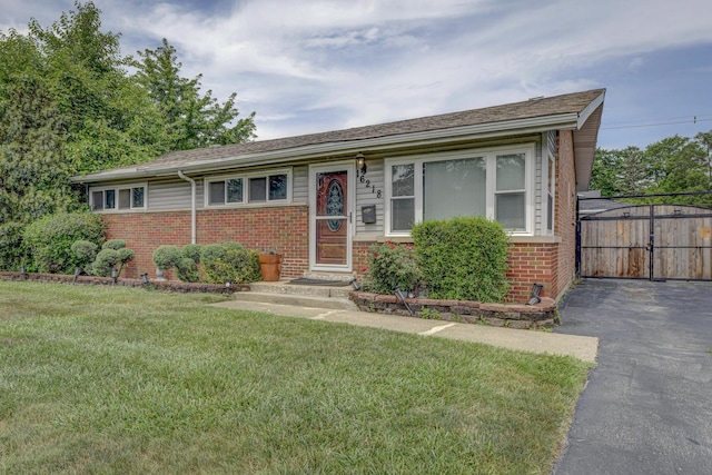 16218 Sussex Ct, Markham, IL 60428 - view of front of property featuring brick siding, a front yard, a gate, and driveway