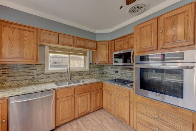 16218 Sussex Ct, Markham, IL 60428 - kitchen with appliances with stainless steel finishes, decorative backsplash, light wood-style flooring, light stone counters, and crown molding