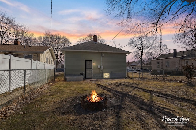 245 N 6th Ave, Kankakee, IL 60901 - rear view of property featuring an outdoor fire pit, a chimney, and a fenced backyard