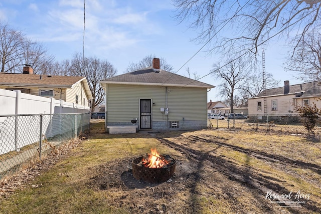 245 N 6th Ave, Kankakee, IL 60901 - back of property with a fire pit, a chimney, and a fenced backyard